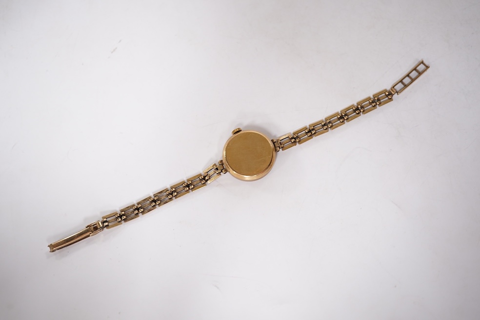 A lady's 9ct gold Vertex manual wind wrist watch, with Arabic dial and subsidiary seconds, on a 9ct gold associated bracelet, gross weight 15 grams. Condition - poor